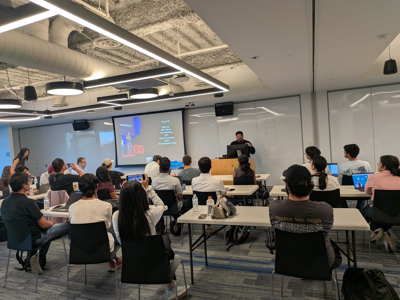 The kickoff talk with past hackathon wins on screen