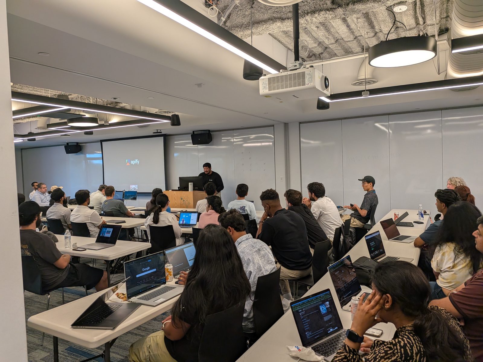 Petros Hong presenting Apify Power to the Builders at the podium