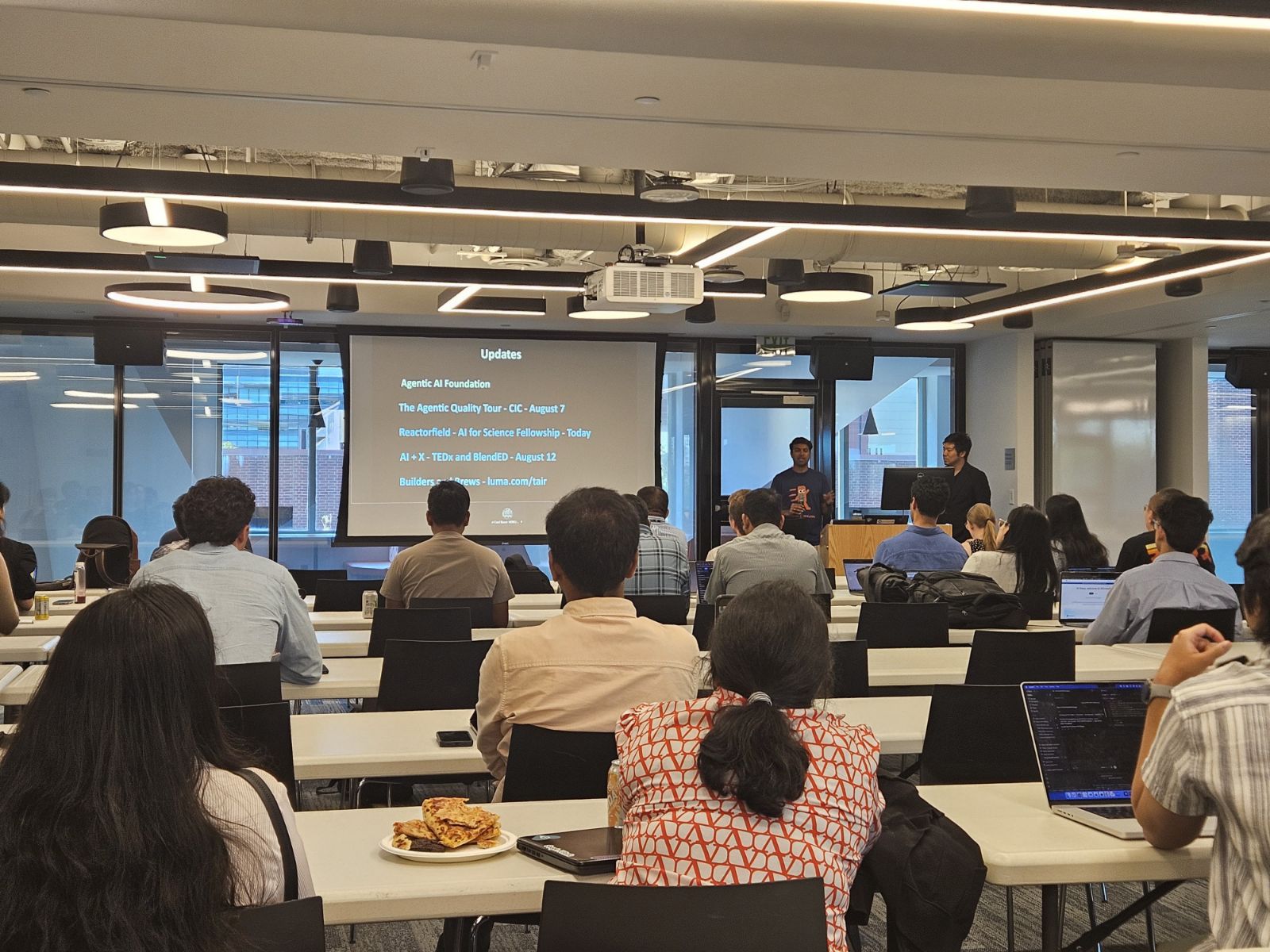 Kranthi Manchikanti opening the night with community updates at The AI Runtime Boston